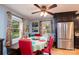 Cozy dining area with stainless steel refrigerator, hardwood floors, and natural light at 4145 Wrangler Sw Dr, Concord, NC 28027