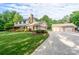 Charming two-story home featuring an attached garage, a detached three-car garage, and a well-manicured front lawn at 4145 Wrangler Sw Dr, Concord, NC 28027