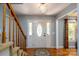 Welcoming foyer featuring hardwood floors, decorative lighting, staircase, and stained glass door at 4145 Wrangler Sw Dr, Concord, NC 28027