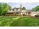Charming two-story brick home featuring a large, well-manicured front yard with mature landscaping at 4145 Wrangler Sw Dr, Concord, NC 28027