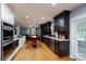 Spacious kitchen featuring stainless steel appliances, granite countertops, a center island, and hardwood floors at 4145 Wrangler Sw Dr, Concord, NC 28027