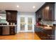 Dark wood cabinets, granite countertops, stainless steel appliances, and a view to the backyard at 4145 Wrangler Sw Dr, Concord, NC 28027