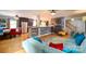 Spacious living room featuring hardwood floors, large sofa, and open access to the kitchen at 4145 Wrangler Sw Dr, Concord, NC 28027