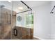 Modern shower with tile surround, rainfall showerhead, and glass door at 4145 Wrangler Sw Dr, Concord, NC 28027