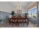 Elegant dining room featuring a wood table, decorative chandelier, wainscoting, and natural light from the window at 4316 Nesbit Rd, Monroe, NC 28112