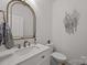Stylish powder room featuring a marble countertop vanity and modern, decorative wall art at 4316 Nesbit Rd, Monroe, NC 28112