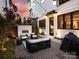 Beautiful backyard with a brick fireplace, cozy seating area, manicured landscaping, and string lights for evening ambiance at 443 Beaumont Ave, Charlotte, NC 28204