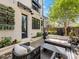 Relaxing backyard patio featuring an outdoor seating area, lush landscaping, and charming string lights at 443 Beaumont Ave, Charlotte, NC 28204