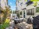 Serene backyard patio featuring an outdoor fireplace, lush greenery, and elegant seating for relaxation at 443 Beaumont Ave, Charlotte, NC 28204