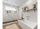 Elegant bathroom featuring a modern soaking tub, glass-enclosed shower, marble walls, and gold accents at 443 Beaumont Ave, Charlotte, NC 28204