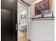 Bright bathroom featuring a soaking tub, black sliding door, and a stylish decorative shelf at 443 Beaumont Ave, Charlotte, NC 28204