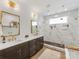 Beautiful bathroom featuring double vanity, custom cabinetry, marble walk-in shower, and gold fixtures at 443 Beaumont Ave, Charlotte, NC 28204