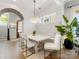 Dining room area featuring a stylish light fixture, neutral chairs, and a built-in bench at 443 Beaumont Ave, Charlotte, NC 28204