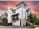 Striking modern home with a painted brick facade, multiple balconies, and a brick driveway at 443 Beaumont Ave, Charlotte, NC 28204