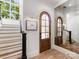 Bright foyer featuring a wood door with glass, staircase, and decorative mirror, creating a welcoming entrance at 443 Beaumont Ave, Charlotte, NC 28204
