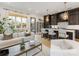Open-concept living area with a modern kitchen featuring dark cabinetry and a spacious island at 443 Beaumont Ave, Charlotte, NC 28204
