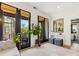 Bright living room featuring black-trimmed glass doors leading to a balcony, modern decor, and natural light at 443 Beaumont Ave, Charlotte, NC 28204