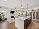 Open floor plan with an island and a living room with a fireplace and TV above at 443 Beaumont Ave, Charlotte, NC 28204
