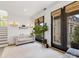 Cozy sitting room with access to an outdoor patio and a tufted settee at 443 Beaumont Ave, Charlotte, NC 28204
