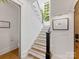 Bright staircase with wooden treads, white risers and a charming window at 443 Beaumont Ave, Charlotte, NC 28204