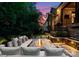 Beautiful backyard patio with a stone fire pit, comfortable seating, manicured landscaping, and a peaceful ambiance at 4635 Harper Ct, Charlotte, NC 28210