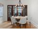 Formal dining room features a modern chandelier, wood table, and six upholstered chairs at 4635 Harper Ct, Charlotte, NC 28210