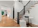 Staircase featuring natural wood stairs and metal railings with an open floor plan at 4635 Harper Ct, Charlotte, NC 28210