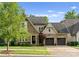 Beautiful brick two-story home featuring manicured lawn, mature trees, and attached two-car garage at 4635 Harper Ct, Charlotte, NC 28210