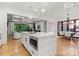 Open kitchen with large center island, stainless appliances, modern lighting, and wood flooring at 4635 Harper Ct, Charlotte, NC 28210