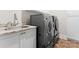 Laundry area with modern side-by-side washer and dryer, and a granite countertop utility sink at 4635 Harper Ct, Charlotte, NC 28210
