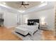 Well-lit main bedroom with a decorative ceiling, fan, and upholstered headboard at 4635 Harper Ct, Charlotte, NC 28210