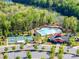 Community amenities, including a pool and tennis courts, are visible from the air, surrounded by lush greenery at 5104 Samoa Ridge Dr, Lancaster, SC 29720