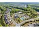 Aerial view of a neighborhood featuring a community pool, tennis courts, and meticulously landscaped streets at 5104 Samoa Ridge Dr, Lancaster, SC 29720