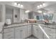 Bathroom featuring double sinks, granite countertops, cabinetry, a walk-in shower, and mirrors at 5104 Samoa Ridge Dr, Lancaster, SC 29720