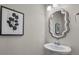 Bathroom featuring a pedestal sink with granite countertop, mirror, lighting, and decorative artwork at 5104 Samoa Ridge Dr, Lancaster, SC 29720