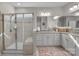 Bathroom featuring double sinks, granite countertops, cabinetry, a walk-in shower, and mirrors at 5104 Samoa Ridge Dr, Lancaster, SC 29720