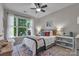 Bedroom with natural lighting, ceiling fan, stylish rug, shelving, and a comfortable bed at 5104 Samoa Ridge Dr, Lancaster, SC 29720