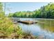Picturesque dock with serene views of the calm lake, offering a tranquil escape for relaxation and water activities at 5104 Samoa Ridge Dr, Lancaster, SC 29720