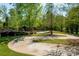 Beautiful paved driveway surrounded by lush greenery and mature trees, offering a scenic entrance to the property at 5104 Samoa Ridge Dr, Lancaster, SC 29720