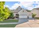Charming two-story home with a three-car garage, manicured lawn, and stone accents for enhanced curb appeal at 5104 Samoa Ridge Dr, Lancaster, SC 29720