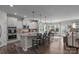 Open-concept kitchen with an island, stainless steel appliances, and a view of the adjacent dining and living areas at 5104 Samoa Ridge Dr, Lancaster, SC 29720