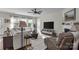 Bright living room featuring a comfortable sofa, large windows, and a cozy fireplace with a mounted television at 5104 Samoa Ridge Dr, Lancaster, SC 29720