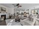 Spacious open-concept living room with a fireplace, ceiling fan, and seamless flow into a modern kitchen at 5104 Samoa Ridge Dr, Lancaster, SC 29720
