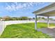 Backyard view featuring well-manicured grass with a white vinyl fence and mature trees at 5146 Elementary View Dr, Charlotte, NC 28269