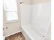 Bathroom featuring white tub with shower, tile floor and window at 5146 Elementary View Dr, Charlotte, NC 28269