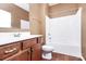 This bathroom is equipped with a shower and sink with wood cabinetry at 5146 Elementary View Dr, Charlotte, NC 28269