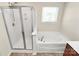 Bathroom with a glass shower and soaking tub with a large window at 5146 Elementary View Dr, Charlotte, NC 28269