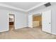 Neutral bedroom with plush carpet, tray ceiling and two large entryways to the hall and bath at 5146 Elementary View Dr, Charlotte, NC 28269