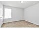 A bright bedroom featuring carpeted floors and a horizontal window at 5146 Elementary View Dr, Charlotte, NC 28269