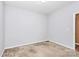 A neutral-colored bedroom featuring carpeted floors and an adjacent bathroom entryway at 5146 Elementary View Dr, Charlotte, NC 28269